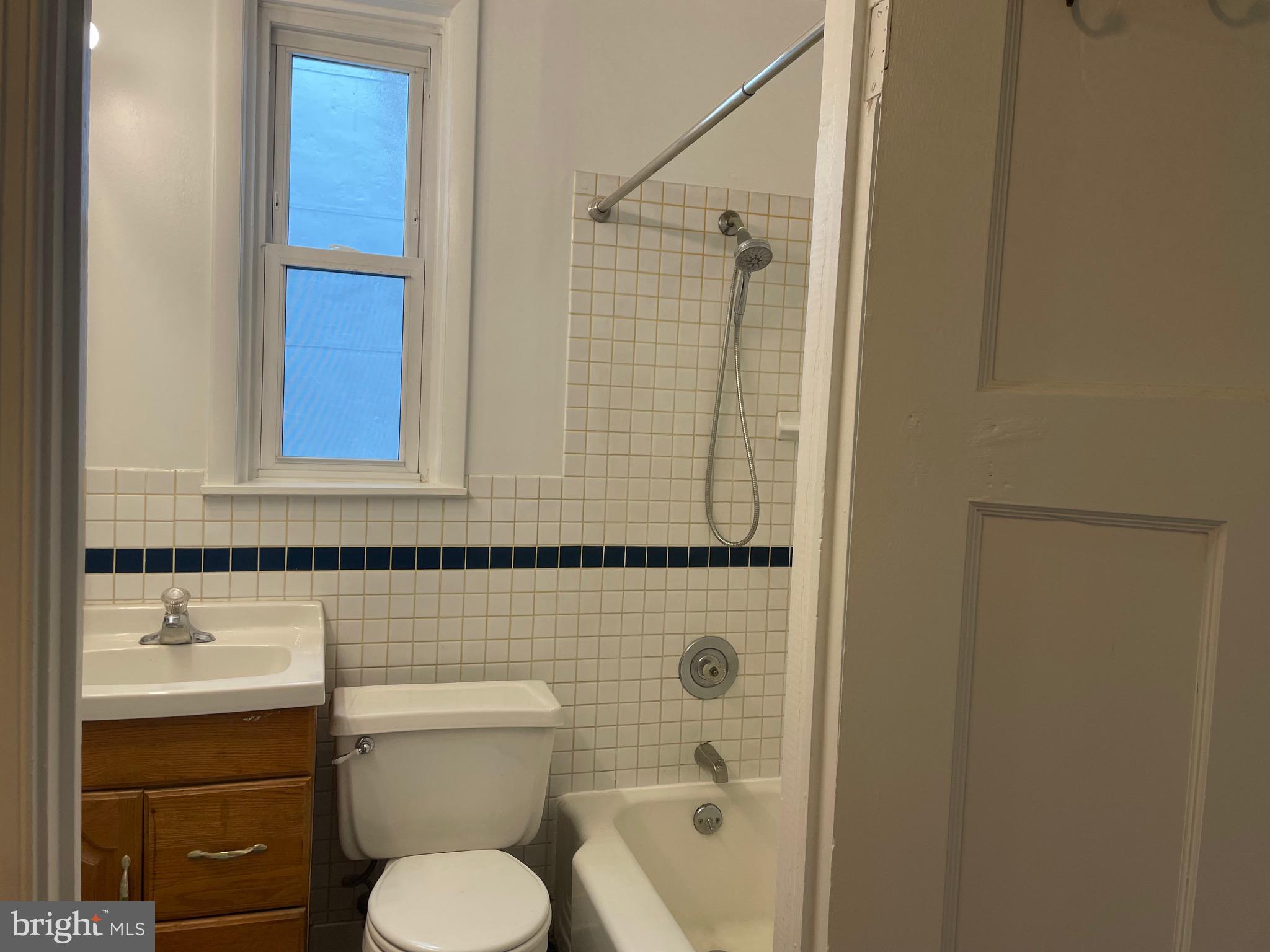 440 Elrino Street, Unit 2 Baltimore, MD 21224 - Photo 7 of 11 a bathroom with a toilet sink and shower