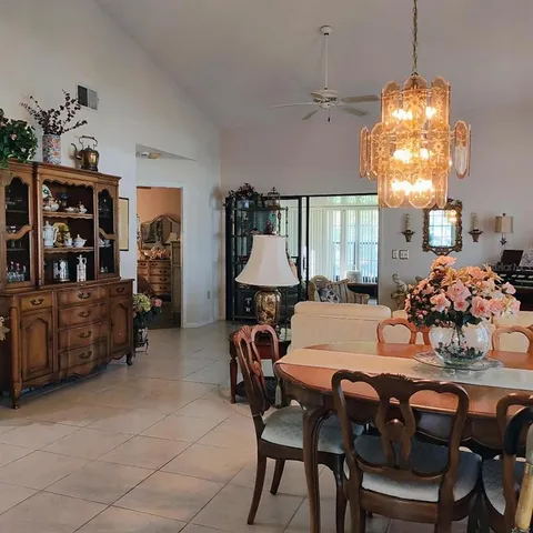 a view of a dining room with furniture and chandelier