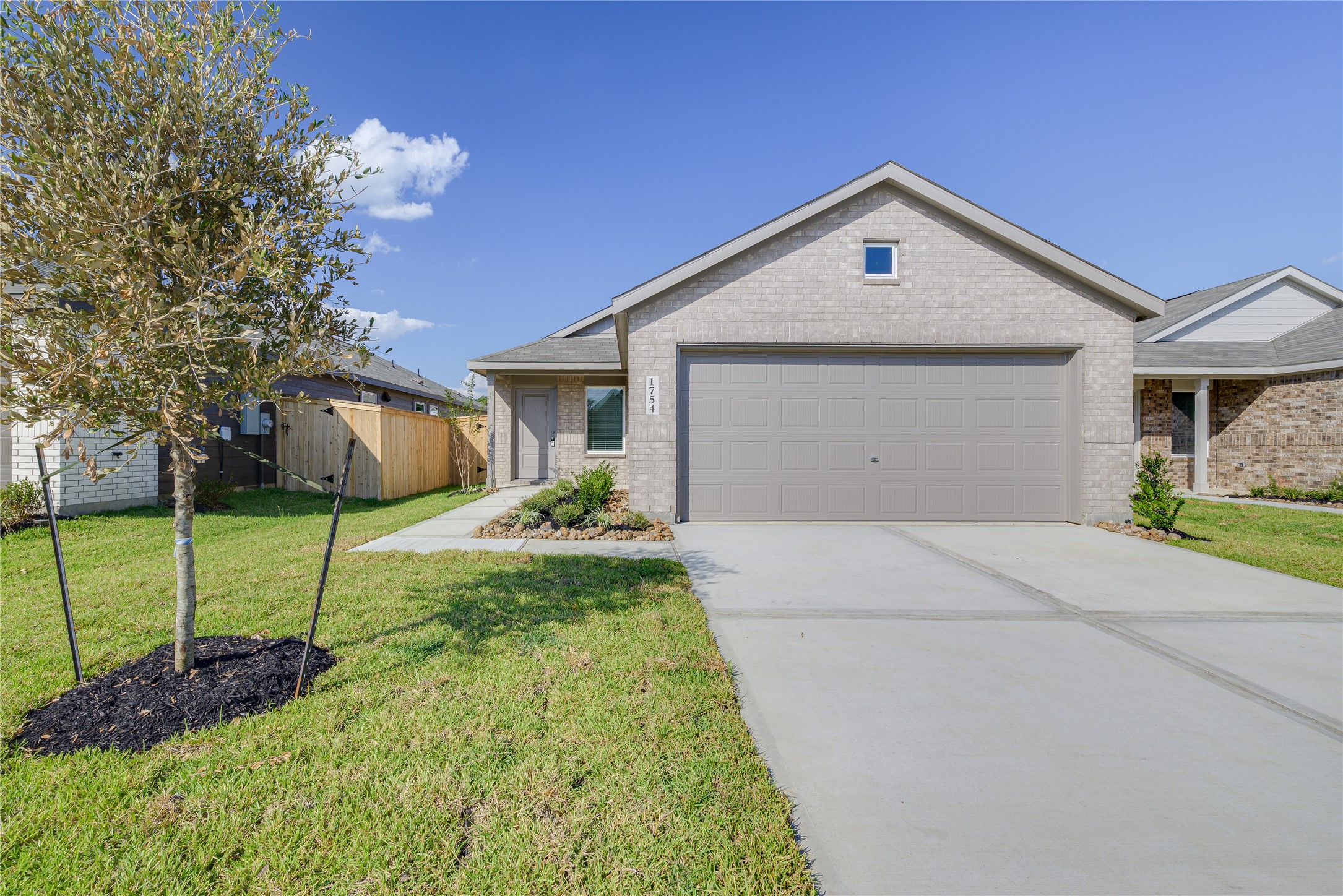 1754 West Stroker Road Crosby, TX 77532 - Photo 1 of 24 a front view of a house with a yard and garage
