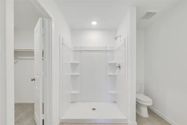 a bathroom with a shower and a toilet
