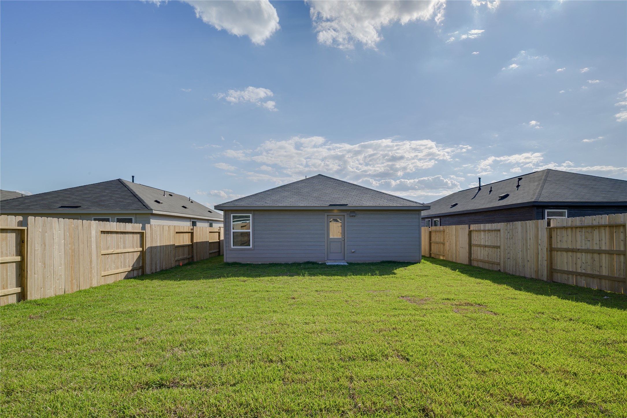 1754 West Stroker Road Crosby, TX 77532 - Photo 23 of 24 a view of a house with a yard and a large tree