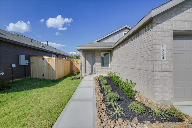 a front view of house with a garden
