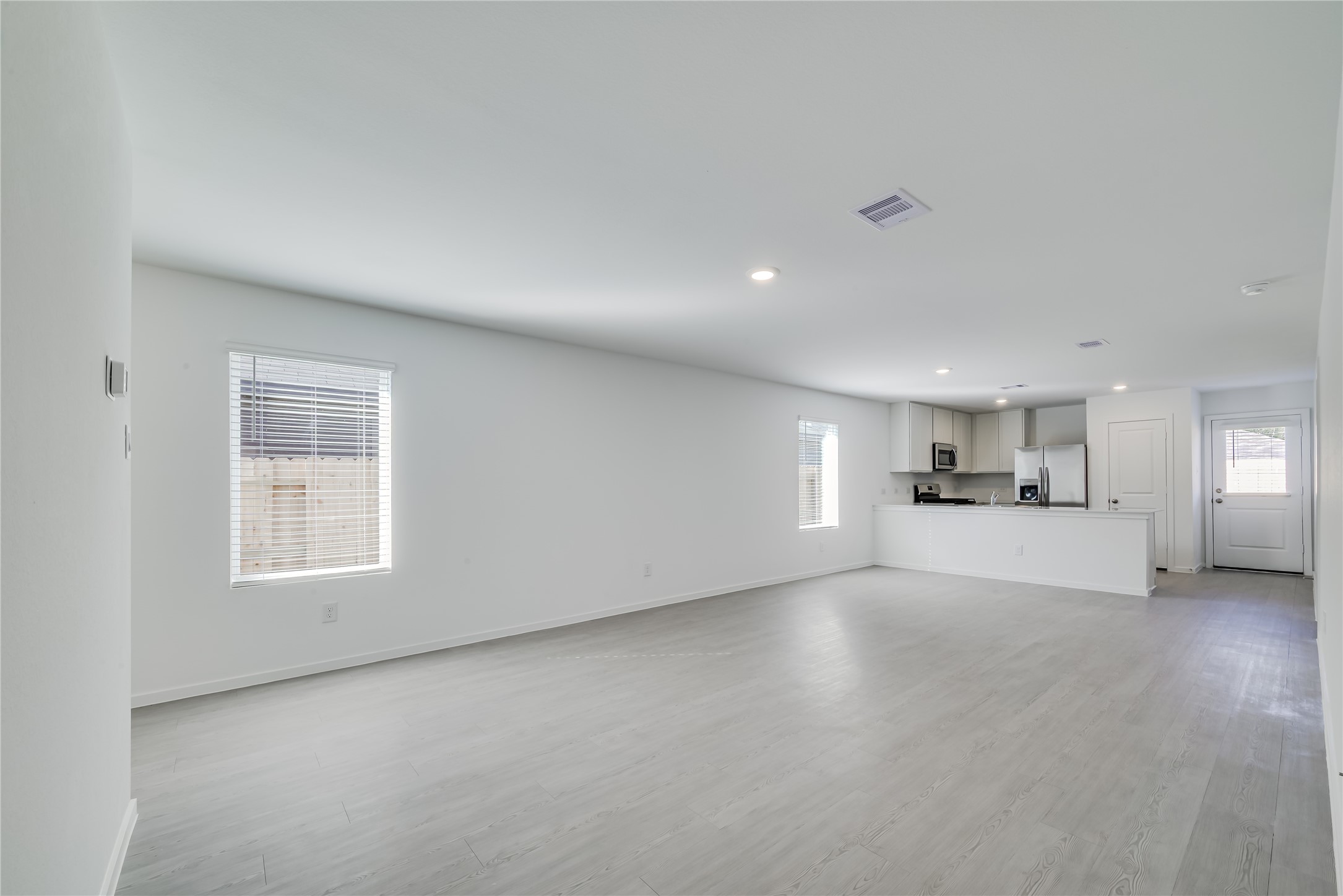 1754 West Stroker Road Crosby, TX 77532 - Photo 5 of 24 a view of empty room with window and wooden floor