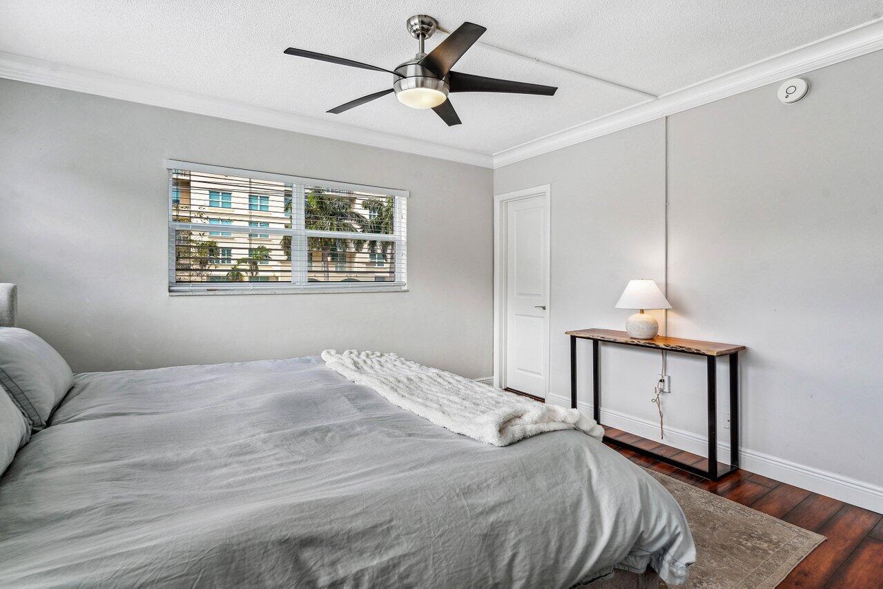 200 East Royal Palm Road, Unit 3120 Boca Raton, FL 33432 - Photo 14 of 27 a bedroom with a large bed a chandelier and a window