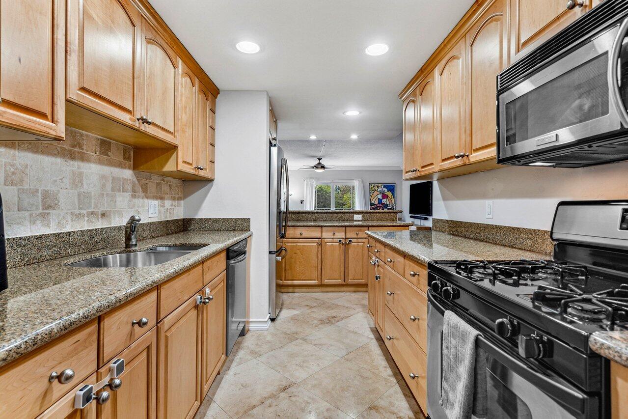 200 East Royal Palm Road, Unit 3120 Boca Raton, FL 33432 - Photo 3 of 27 a kitchen with stainless steel appliances granite countertop a sink stove and cabinets