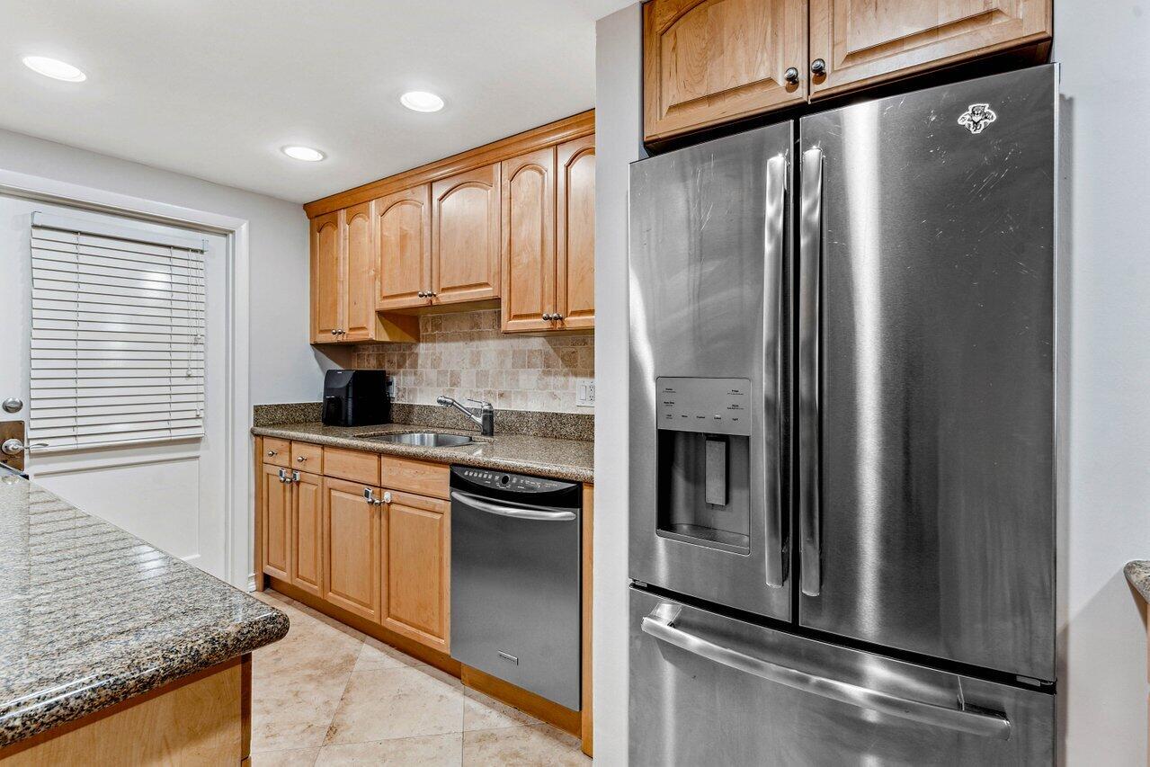 200 East Royal Palm Road, Unit 3120 Boca Raton, FL 33432 - Photo 5 of 27 a kitchen with stainless steel appliances granite countertop a refrigerator a stove and a sink