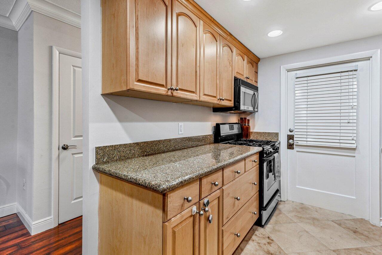 200 East Royal Palm Road, Unit 3120 Boca Raton, FL 33432 - Photo 6 of 27 a kitchen with stainless steel appliances granite countertop a stove a sink and a microwave