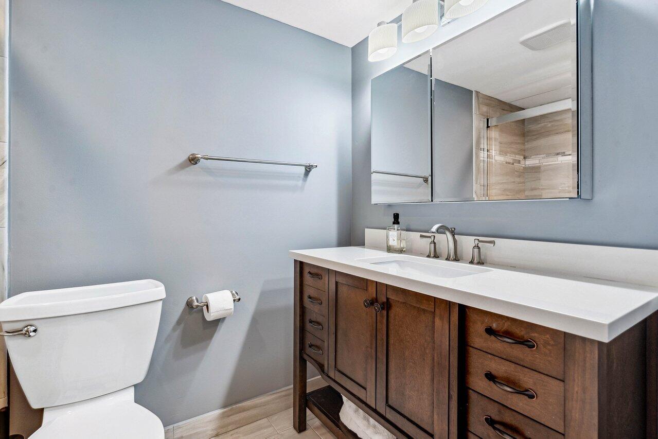 200 East Royal Palm Road, Unit 3120 Boca Raton, FL 33432 - Photo 10 of 27 a bathroom with a toilet sink and mirror