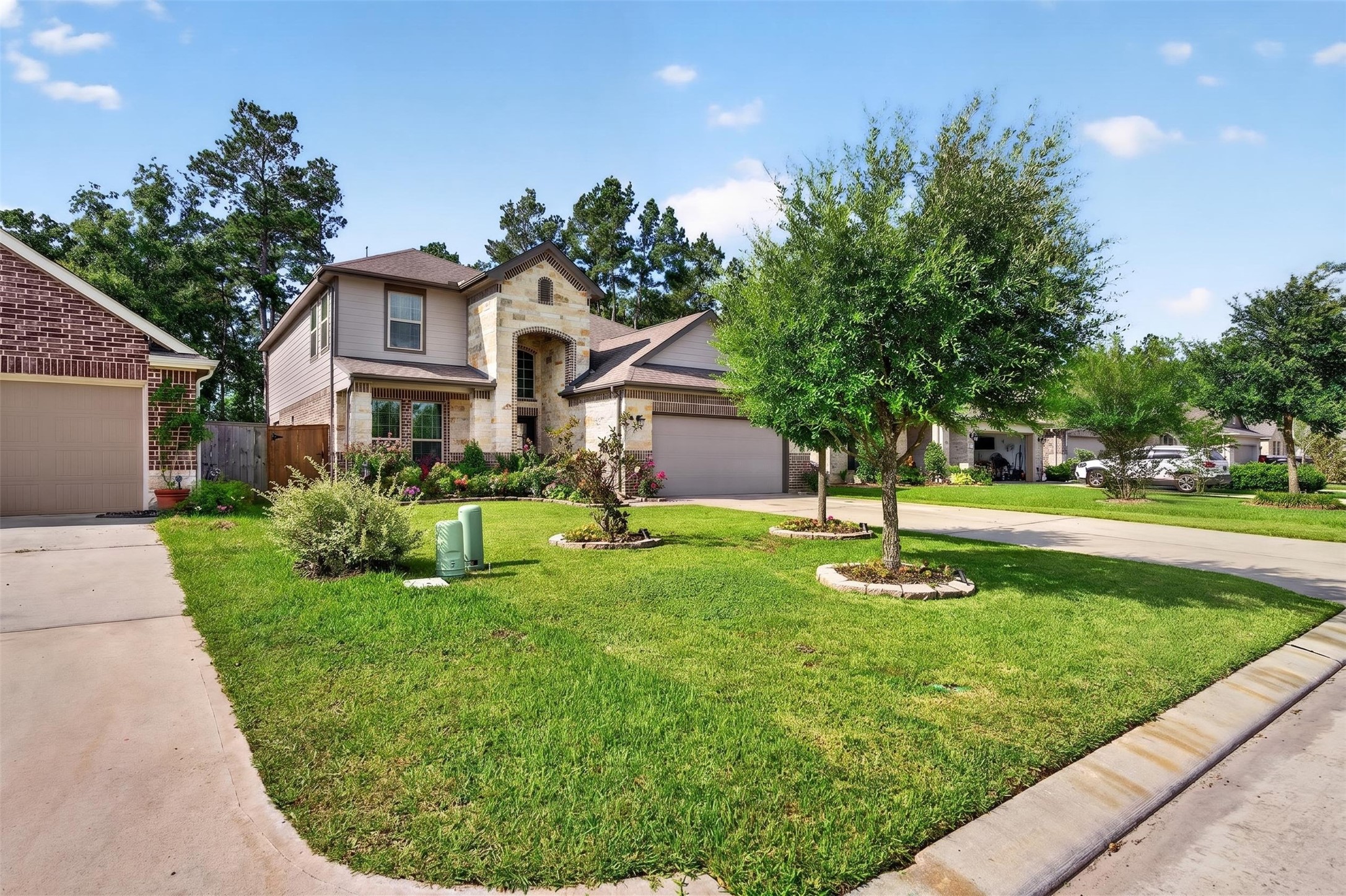 2832 Mistygate Court Conroe, TX 77301 - Photo 44 of 50 Front yard angle showing the lawn, driveway, and tree-lined street setting.
