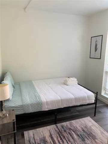 a bed sitting in a bedroom next to a window