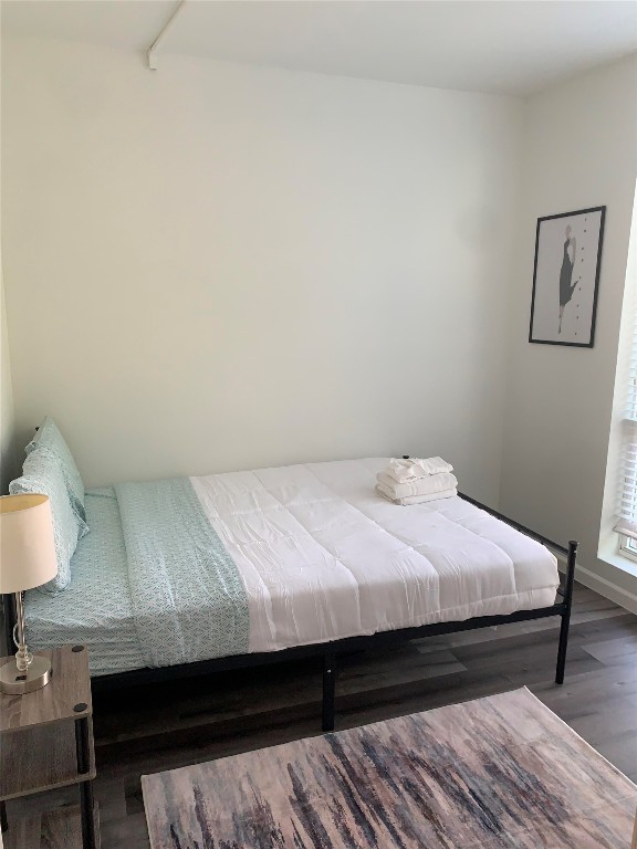 911 West 22nd Street, Unit 305 Austin, TX 78705 - Photo 13 of 15 a bedroom with a bed and a lamp on dresser