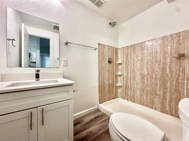 a bathroom with a sink toilet and shower