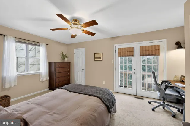 a bedroom with a bed dresser and a window