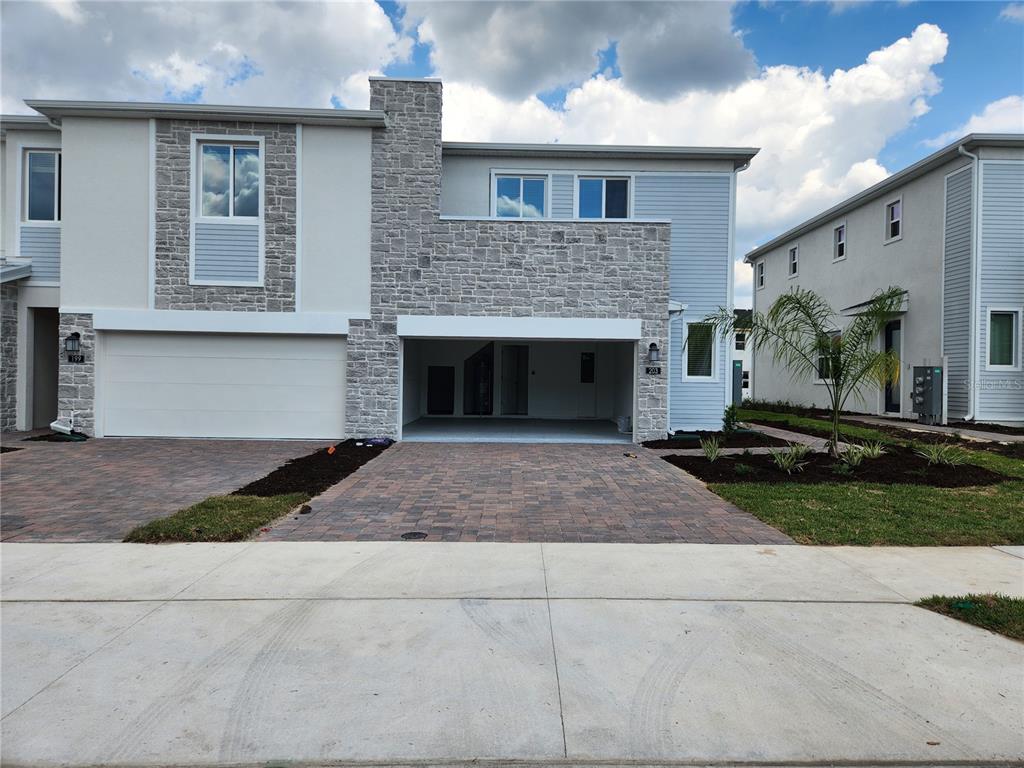 203 Bogey Drive Davenport, FL 33896 - Photo 1 of 41 a front view of a house with a yard and a garage