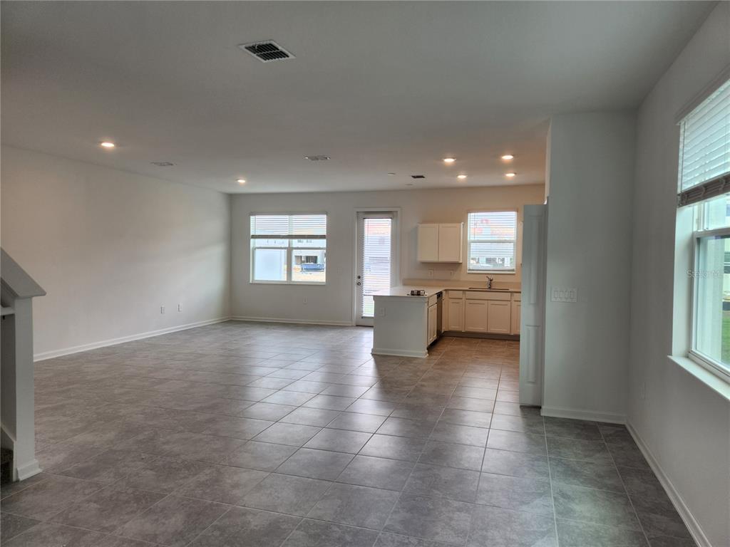 203 Bogey Drive Davenport, FL 33896 - Photo 13 of 41 a view of a big room with windows and cabinet area