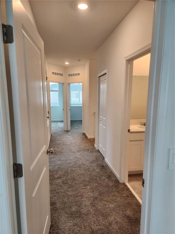 203 Bogey Drive Davenport, FL 33896 - Photo 16 of 41 a view of a hallway with wooden shelves