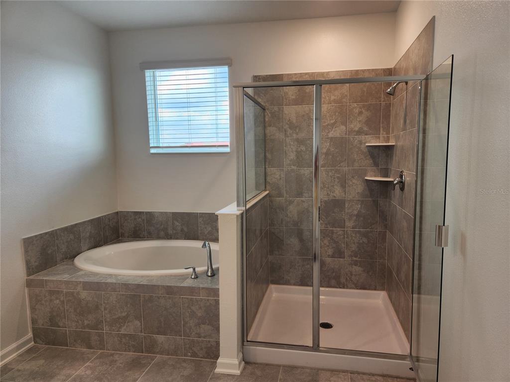203 Bogey Drive Davenport, FL 33896 - Photo 23 of 41 a bathroom with a bath tub and a shower