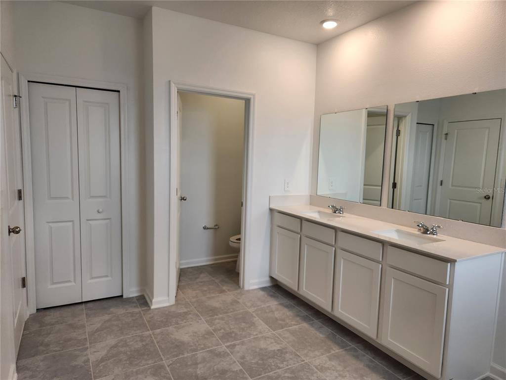 203 Bogey Drive Davenport, FL 33896 - Photo 24 of 41 a bathroom with a double vanity sink and mirror