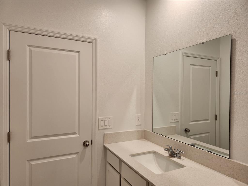 203 Bogey Drive Davenport, FL 33896 - Photo 34 of 41 a bathroom with a sink and a mirror