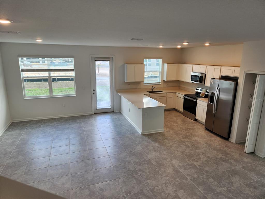 203 Bogey Drive Davenport, FL 33896 - Photo 9 of 41 a view of a kitchen with a sink cabinets and window