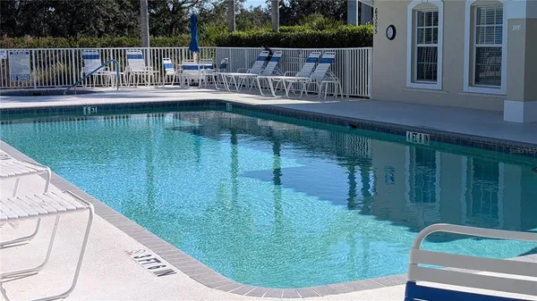 a view of a swimming pool with a patio