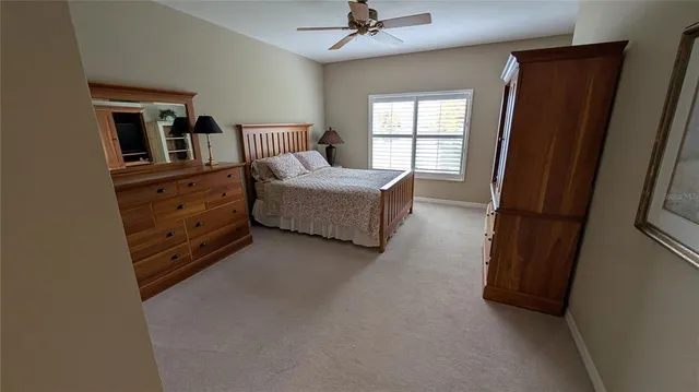 a spacious bedroom with a bed and a window