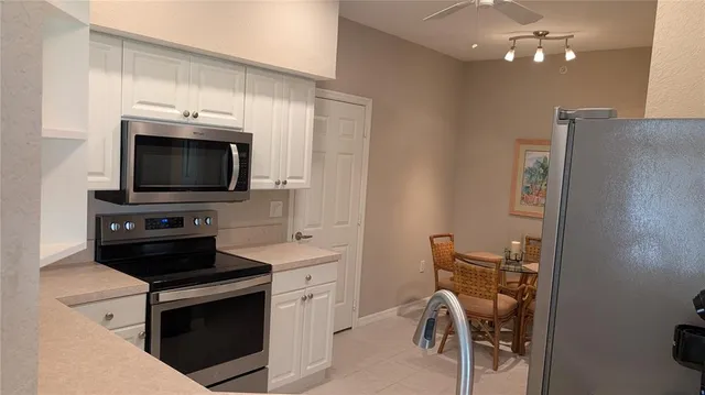 a kitchen with a sink stainless steel appliances and cabinets