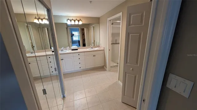 a bathroom with a mirror sink and vanity