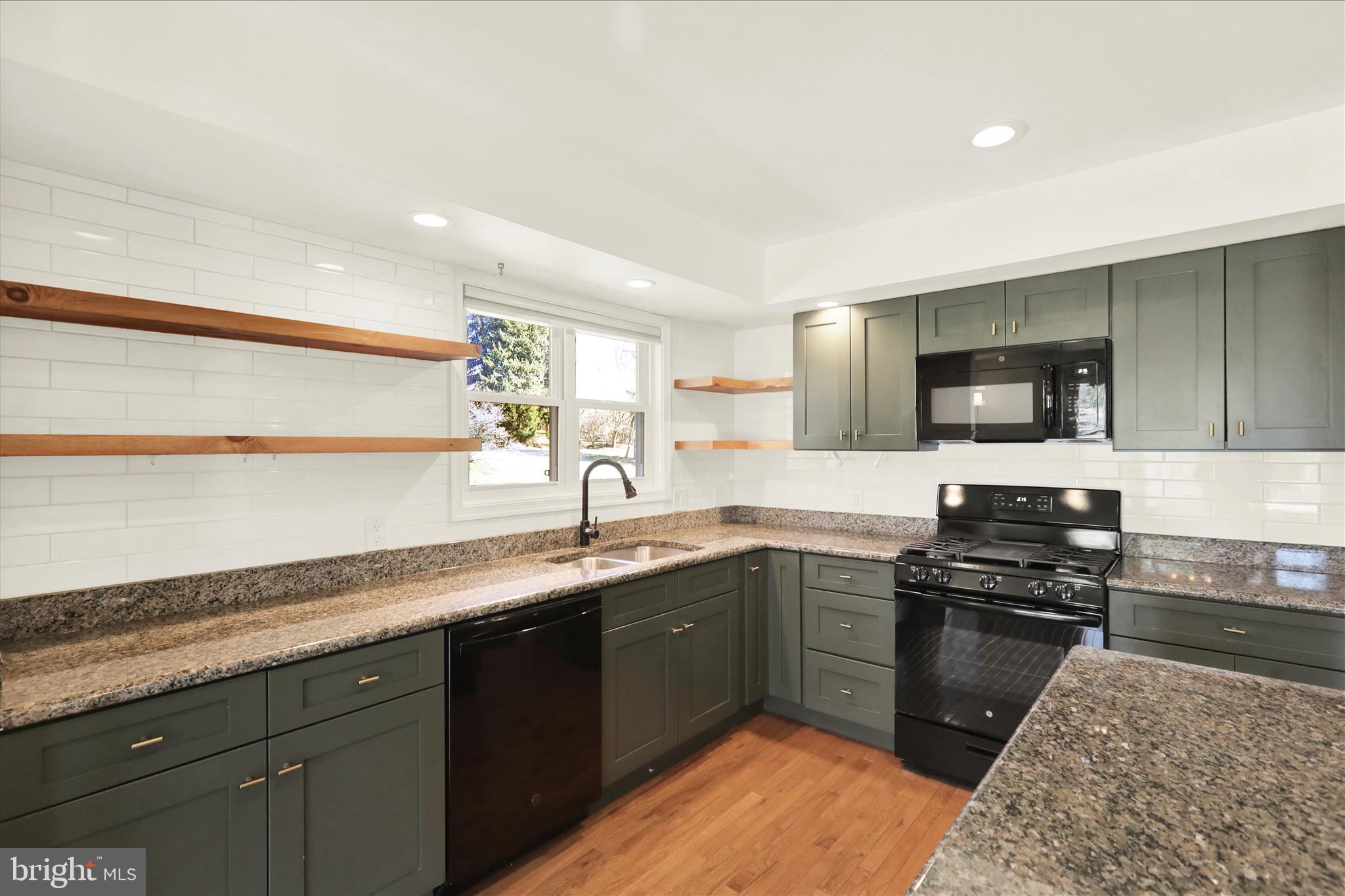 302 South Tulpehocken Road Reading, PA 19601 - Photo 21 of 44 a kitchen with a sink and a stove top oven with wooden floor