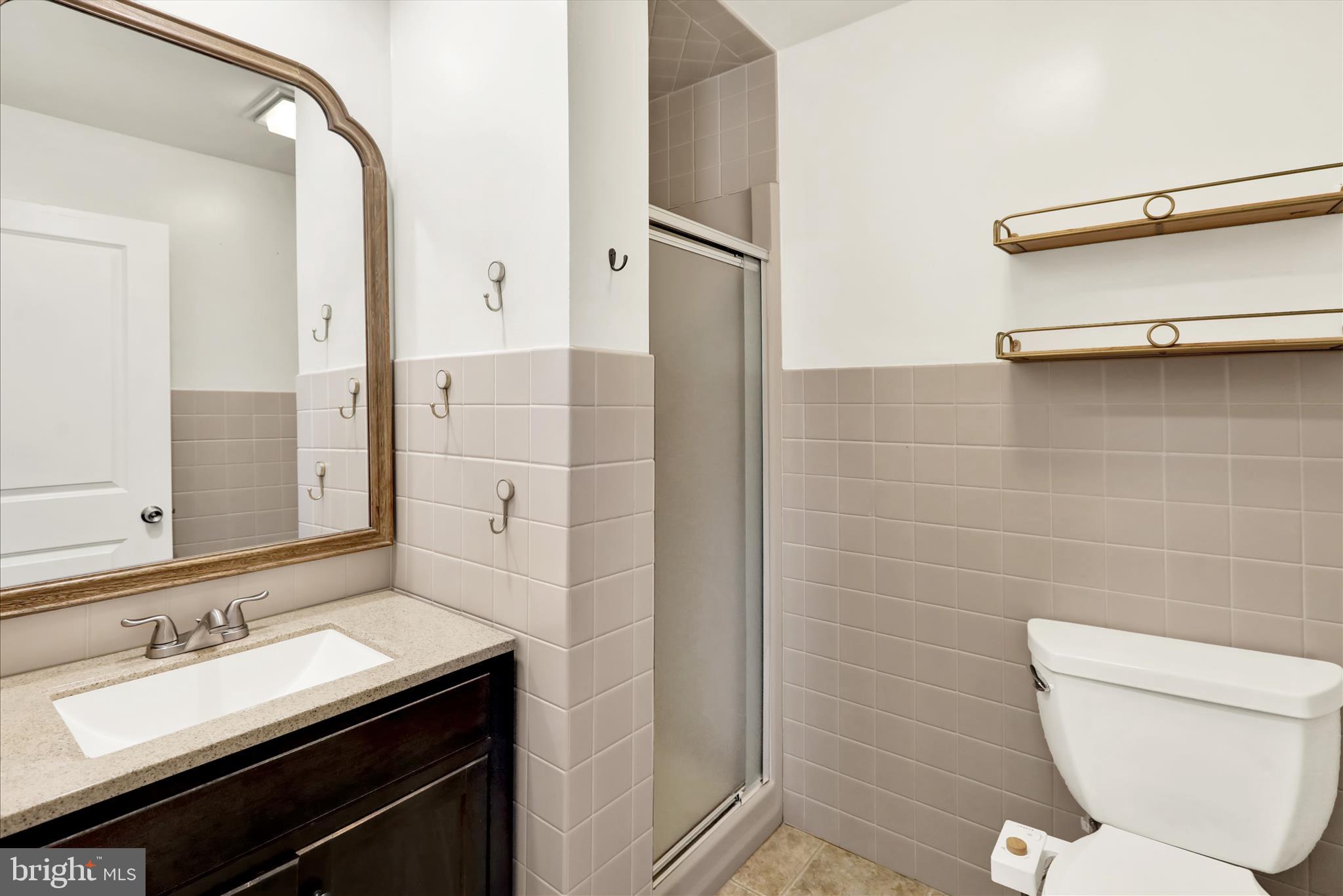302 South Tulpehocken Road Reading, PA 19601 - Photo 33 of 44 a bathroom with a sink a toilet a mirror and shower