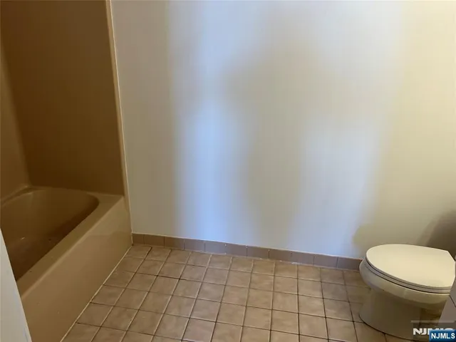 a bathroom with a bathtub and toilet