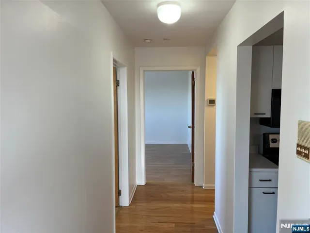 a view of hallway with wooden floor