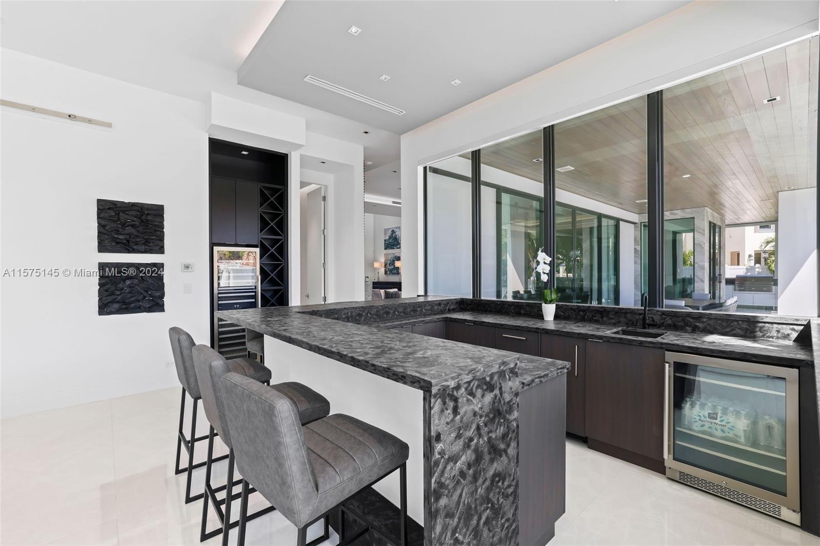 749 Bamboo Drive Boca Raton, FL 33432 - Photo 23 of 91 a kitchen with stainless steel appliances granite countertop a stove a sink and a refrigerator