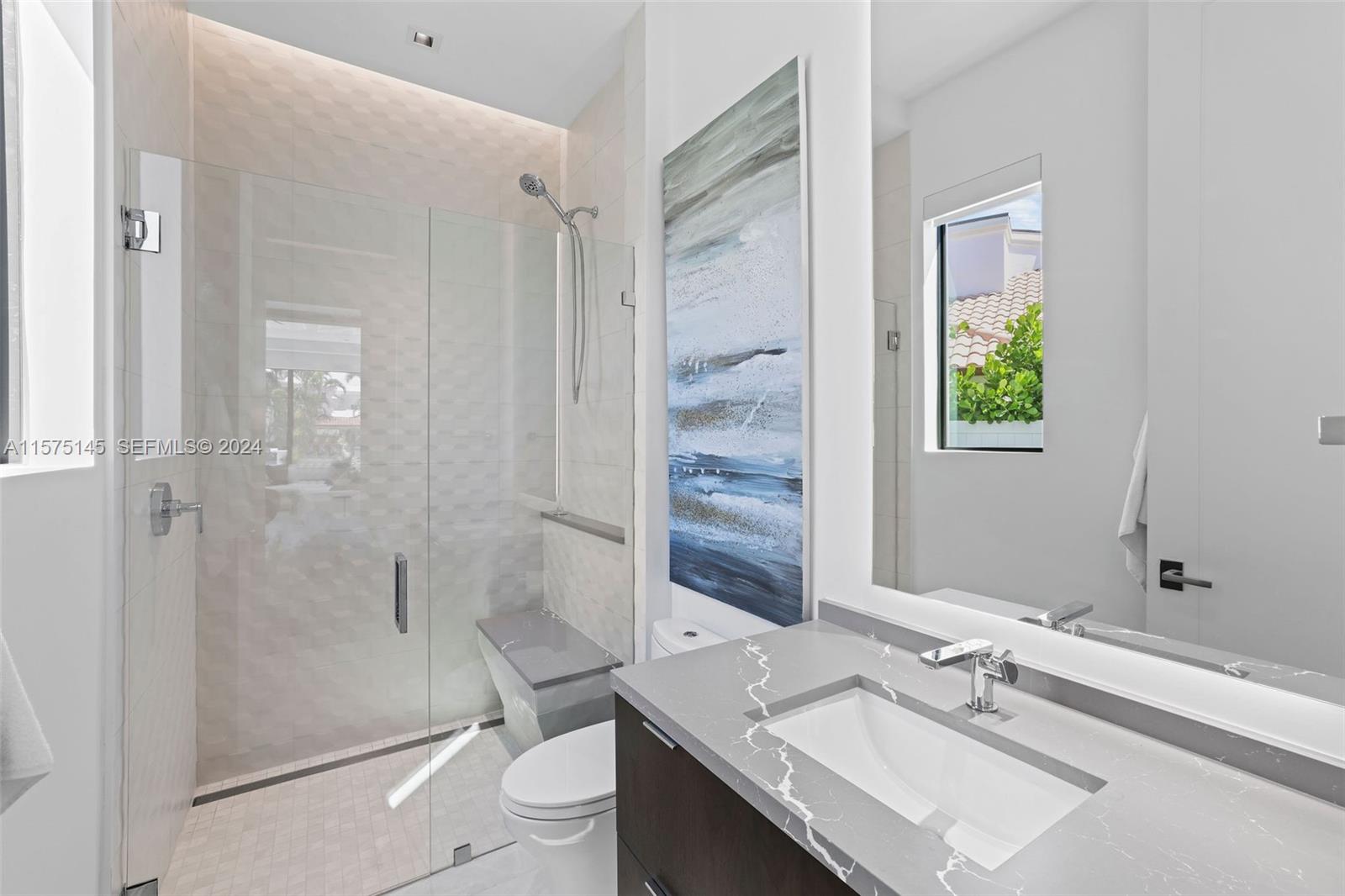 749 Bamboo Drive Boca Raton, FL 33432 - Photo 27 of 91 a bathroom with a sink toilet and shower