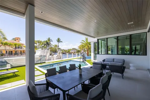 a living room with couch and a floor to ceiling window