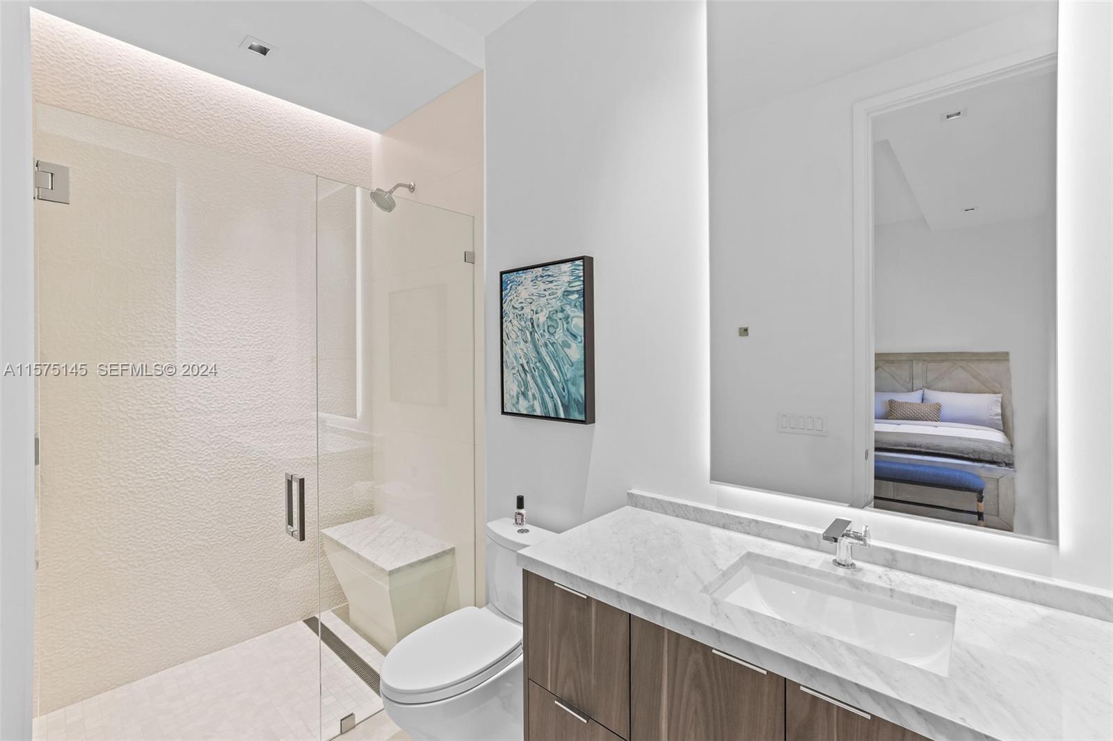 749 Bamboo Drive Boca Raton, FL 33432 - Photo 85 of 91 a bathroom with a granite countertop sink a toilet and a mirror