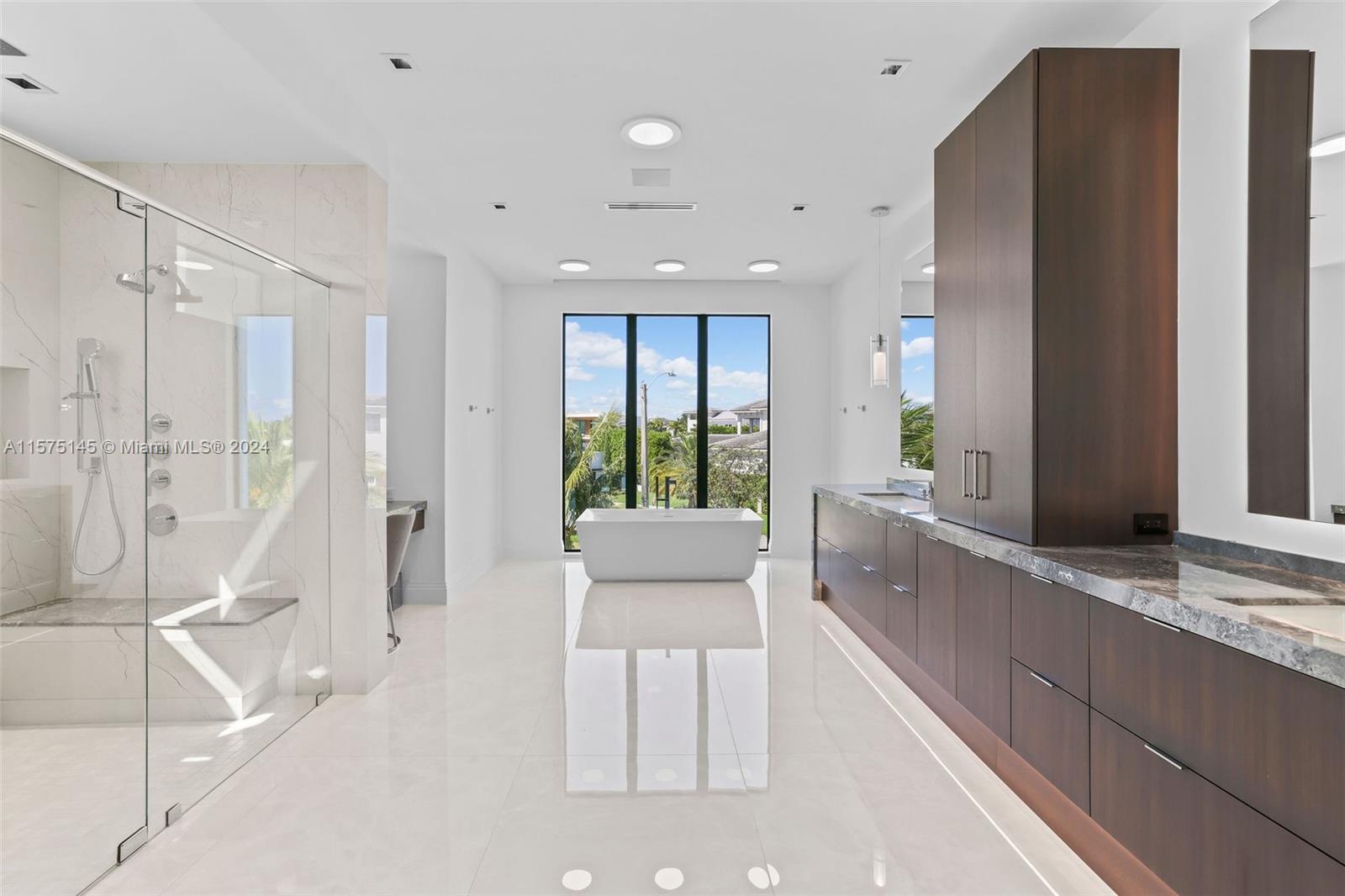 749 Bamboo Drive Boca Raton, FL 33432 - Photo 91 of 91 a large white kitchen with a large window and stainless steel appliances