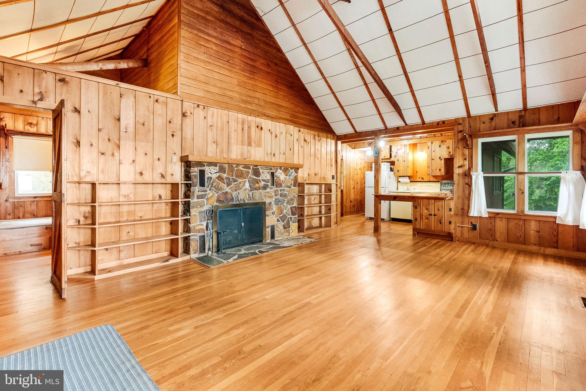 2138 Cedar Road Port Republic, MD 20676 - Photo 4 of 34 a view of an empty room with wooden floor and a fireplace