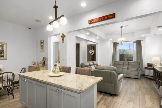 a large living room with granite countertop couches a fireplace with wooden floor