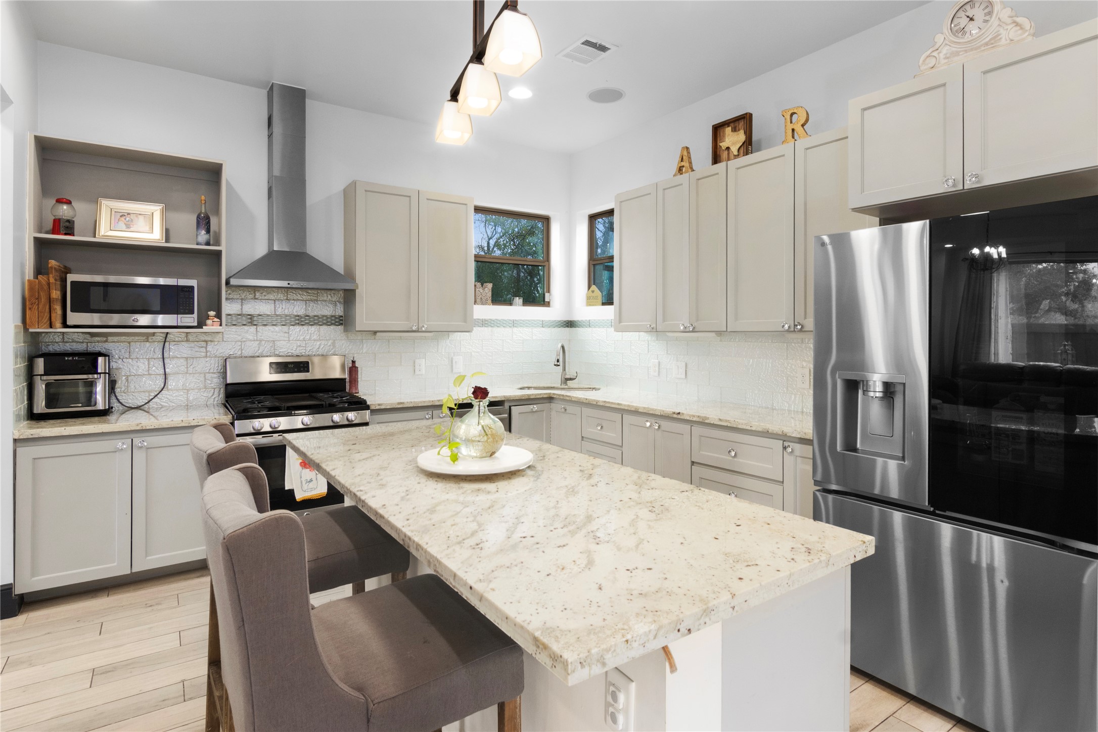 7341 Ave East Houston, TX 77011 - Photo 12 of 33 a kitchen with stainless steel appliances granite countertop a sink stove and refrigerator