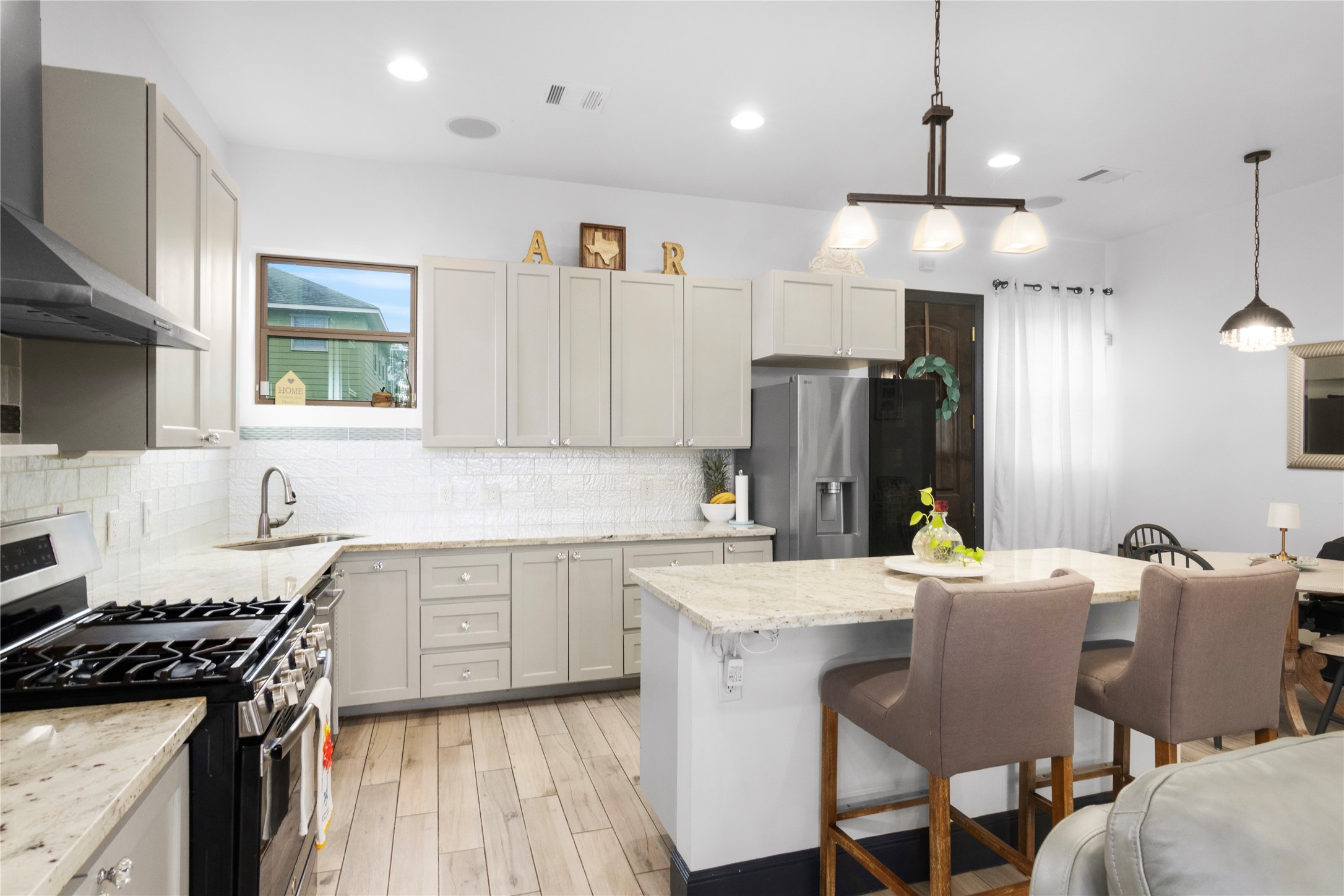 7341 Ave East Houston, TX 77011 - Photo 13 of 33 a kitchen with granite countertop a sink stove and refrigerator