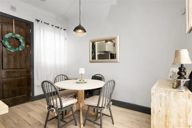 a view of a dining room with furniture and chandelier