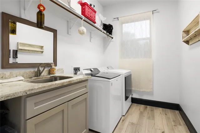 a utility room with sink dryer and washer
