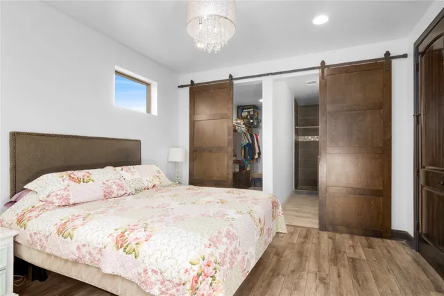 a bedroom with a bed and a refrigerator