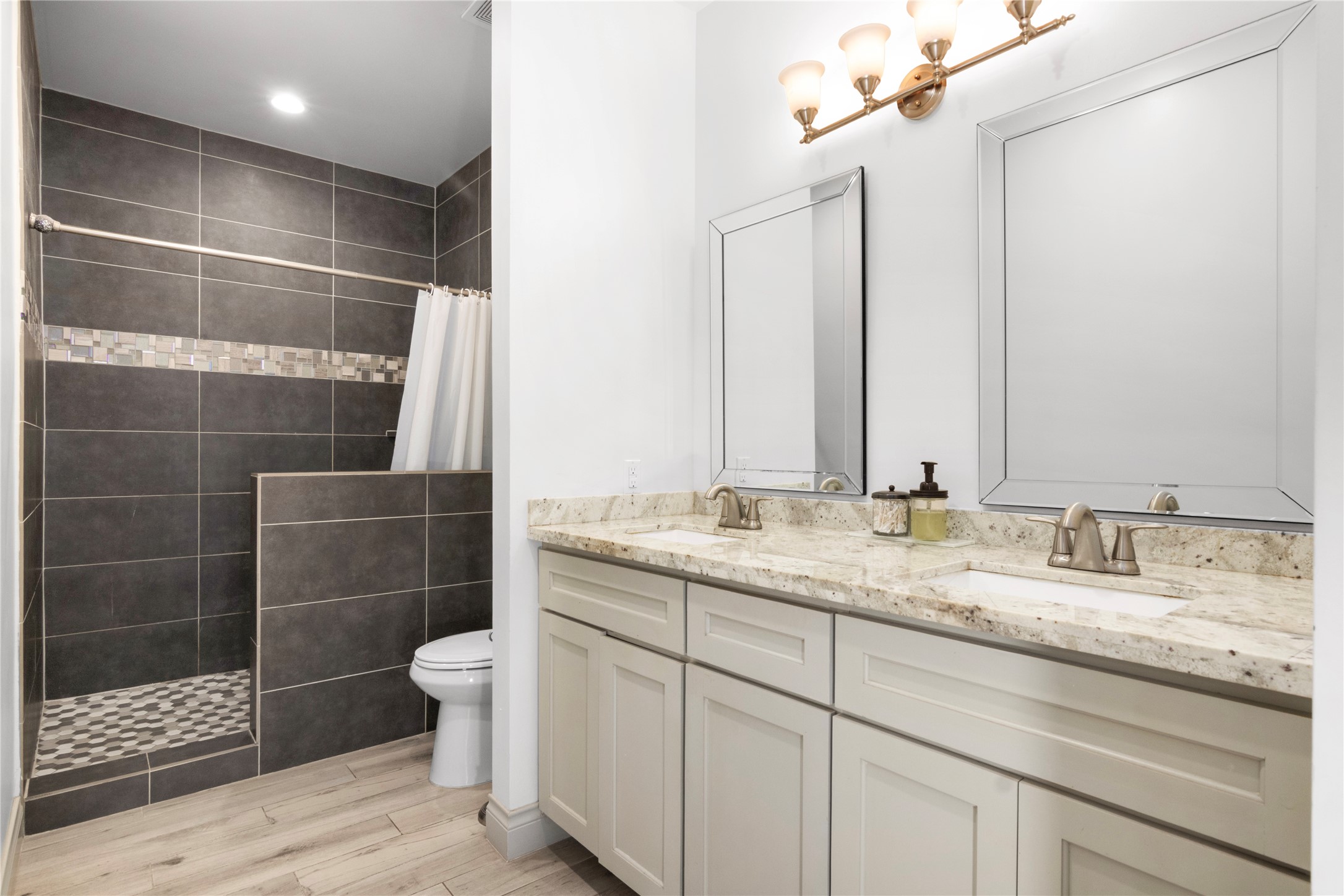 7341 Ave East Houston, TX 77011 - Photo 22 of 33 a bathroom with a double vanity sink toilet and shower