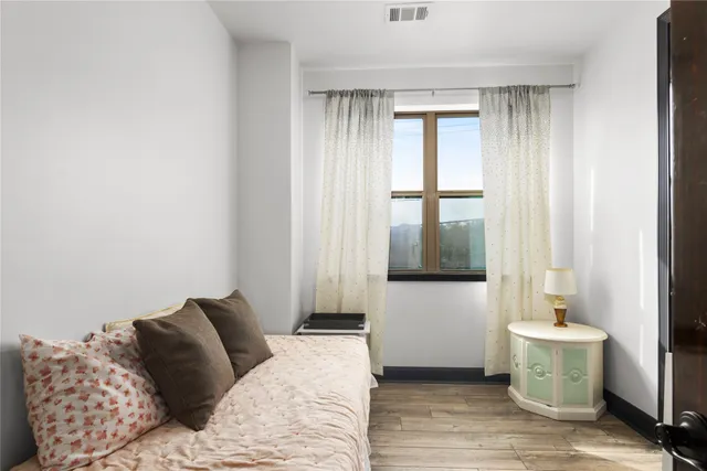 a bedroom with a bed and a window