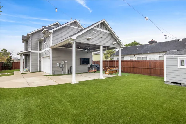 a view of a house with a yard and porch