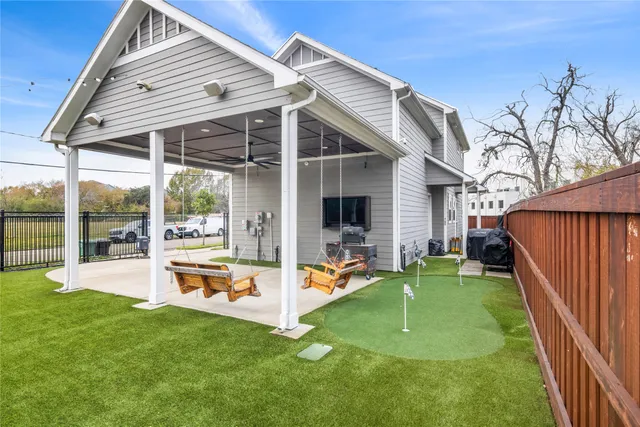 a backyard of a house with table and chairs