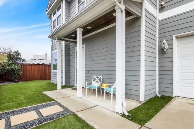 a view of a patio with chairs and a table