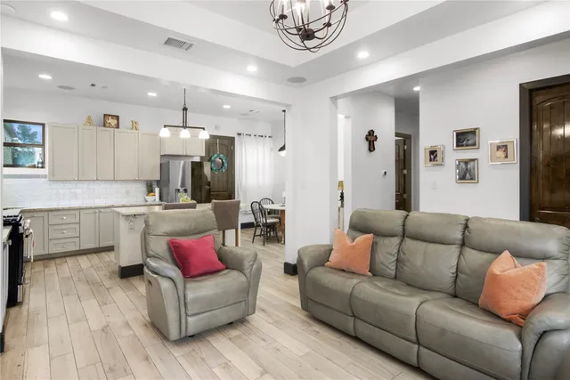 a living room with furniture and kitchen view